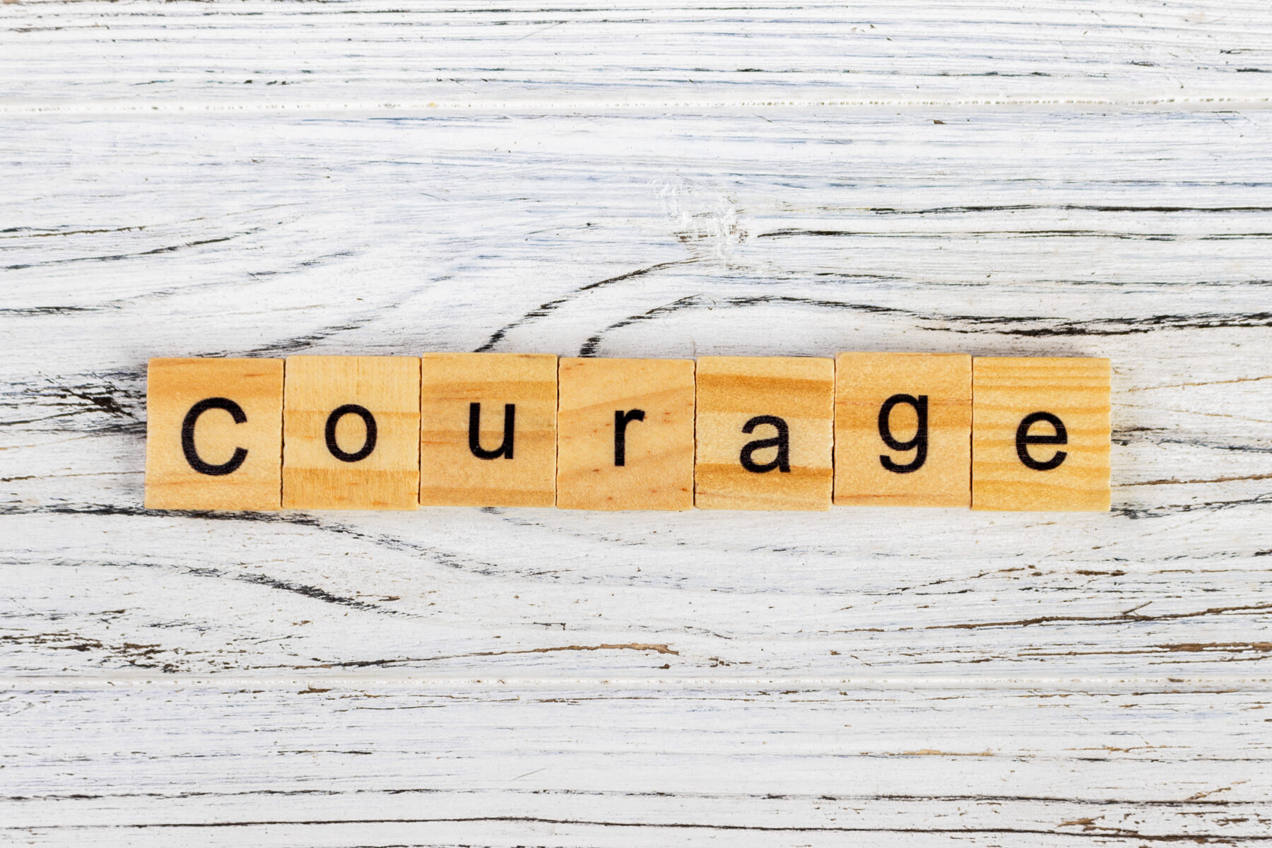photo of the word "courage" in word blocks.
