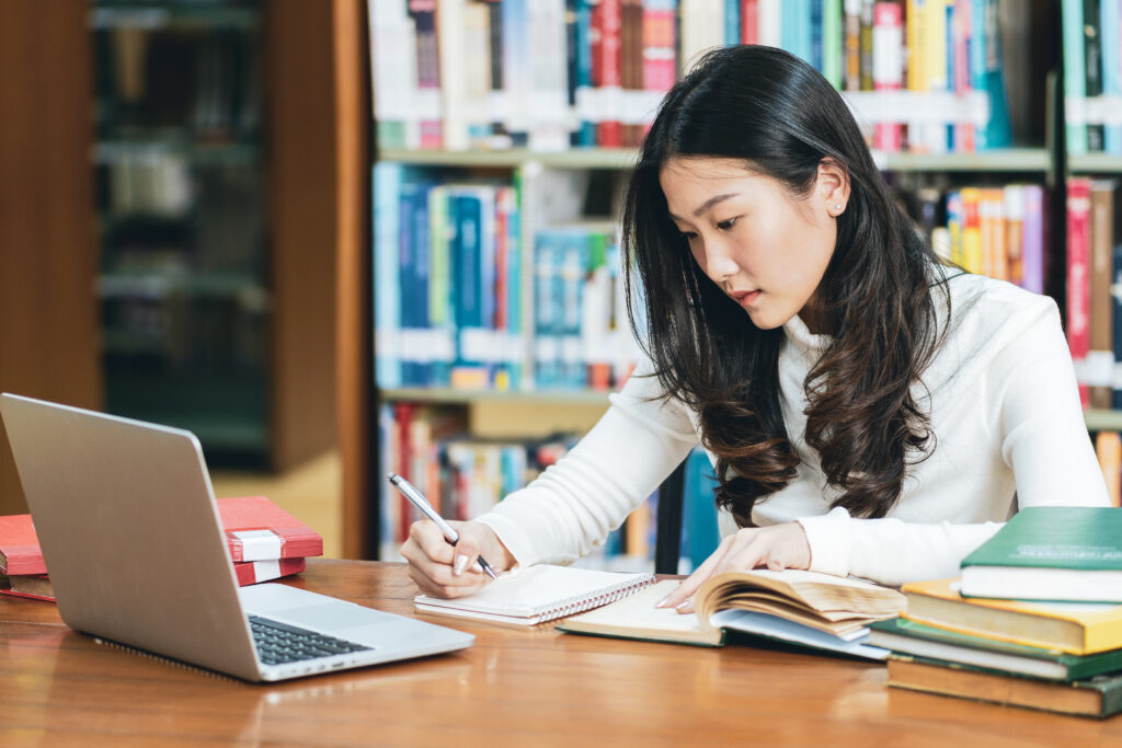 photo of college student studying in a library